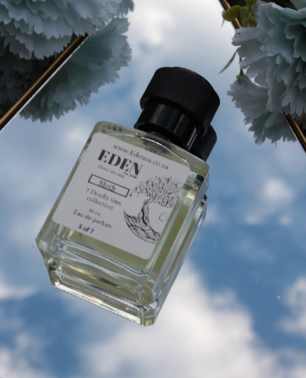 Eden perfume bottle with a floral background
